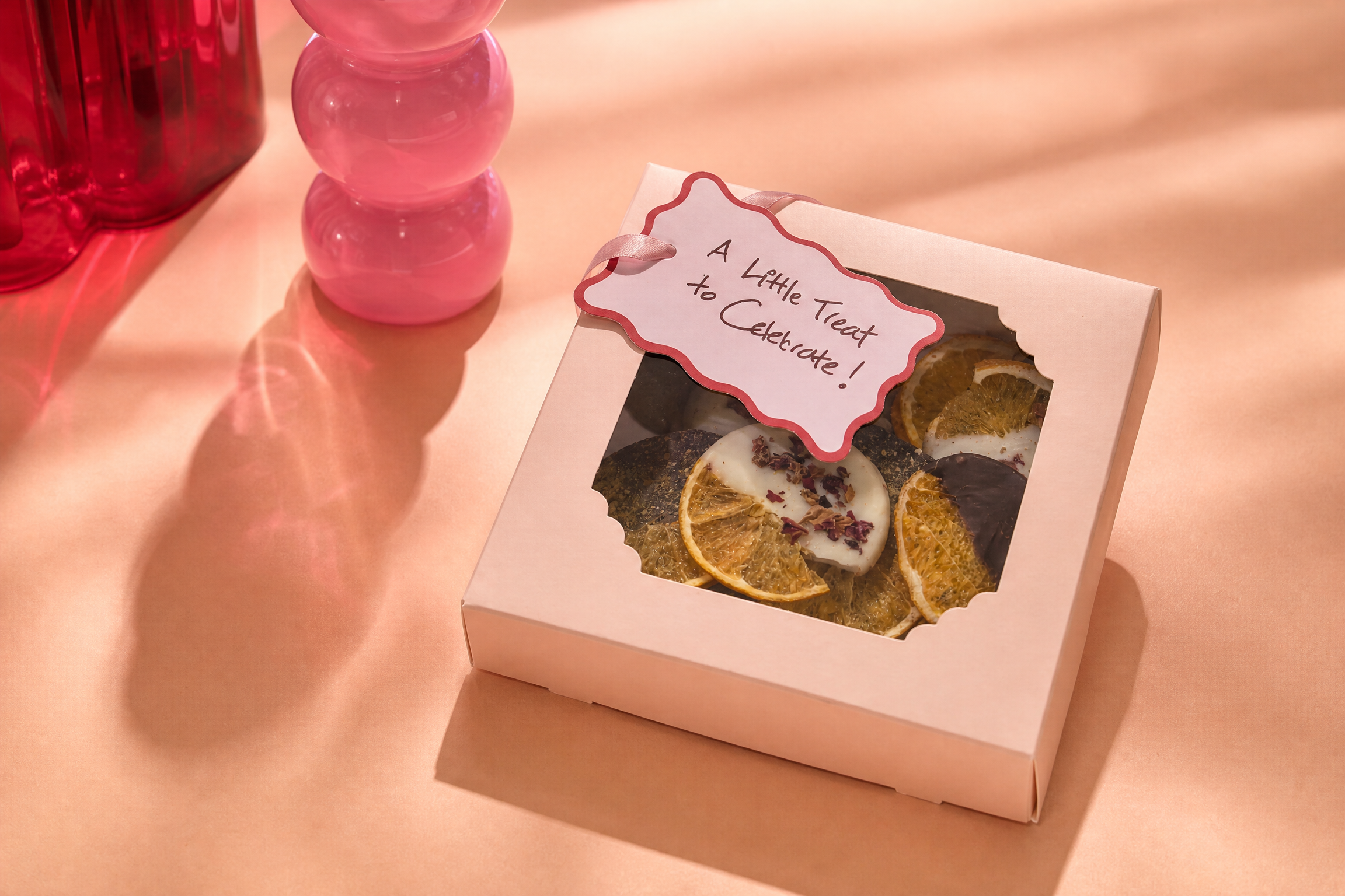 A pink TSGC treat box styled for a celebration